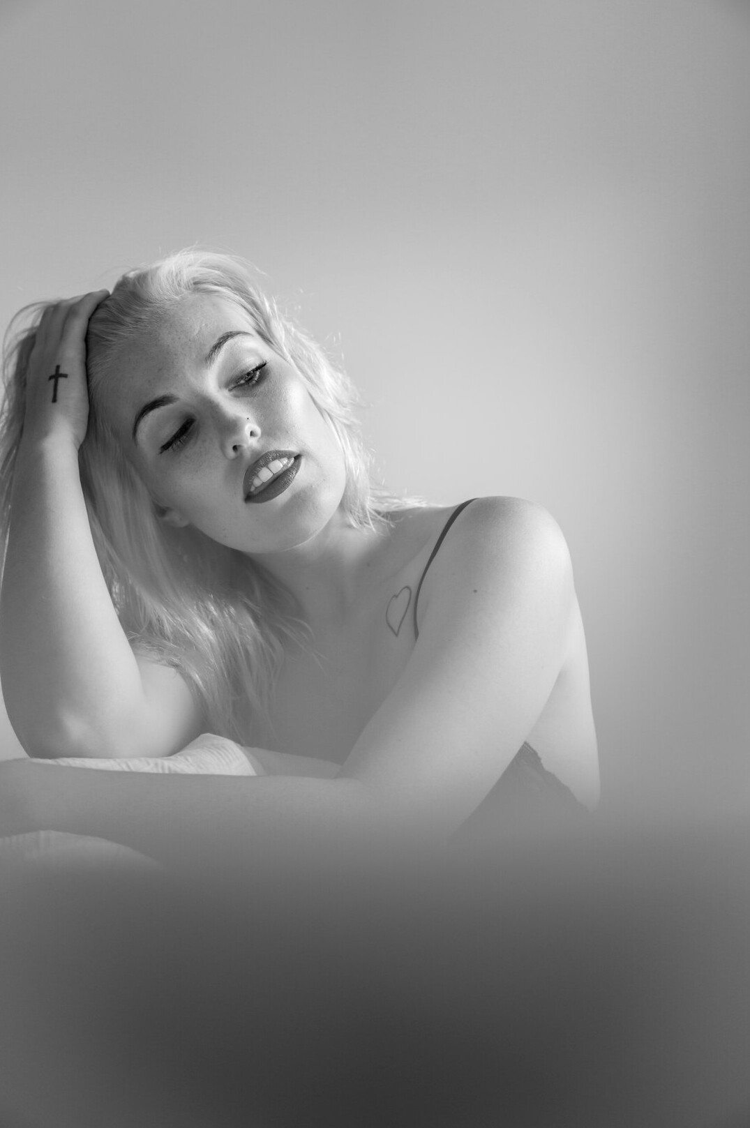 Studio portrait of a woman with blonde hair smiling