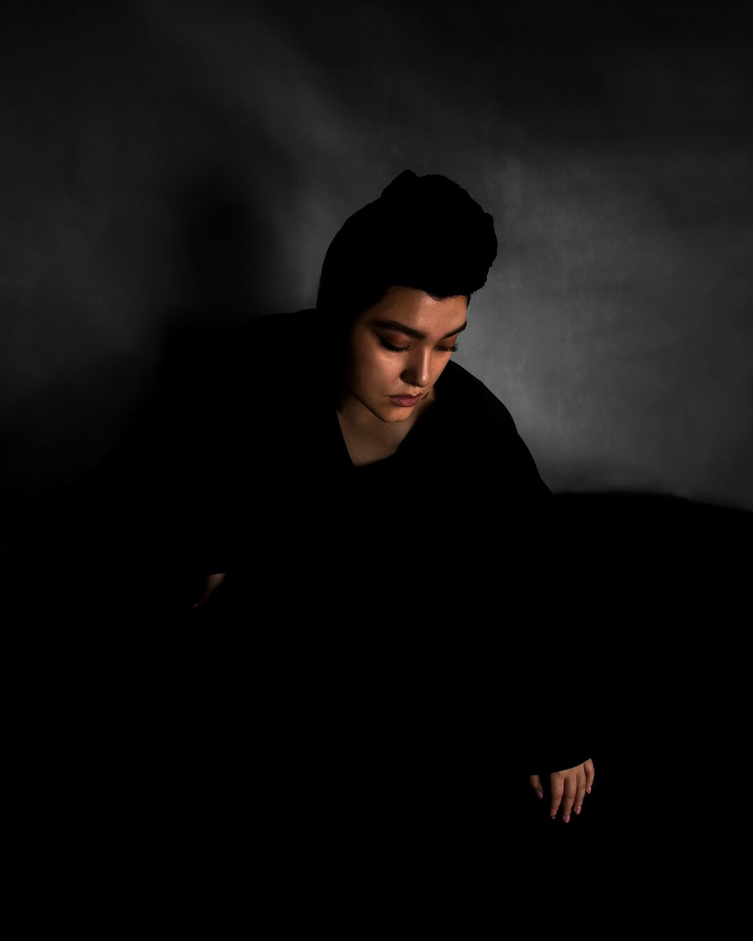 Studio portrait of a man with short dark hair in a dark jacket