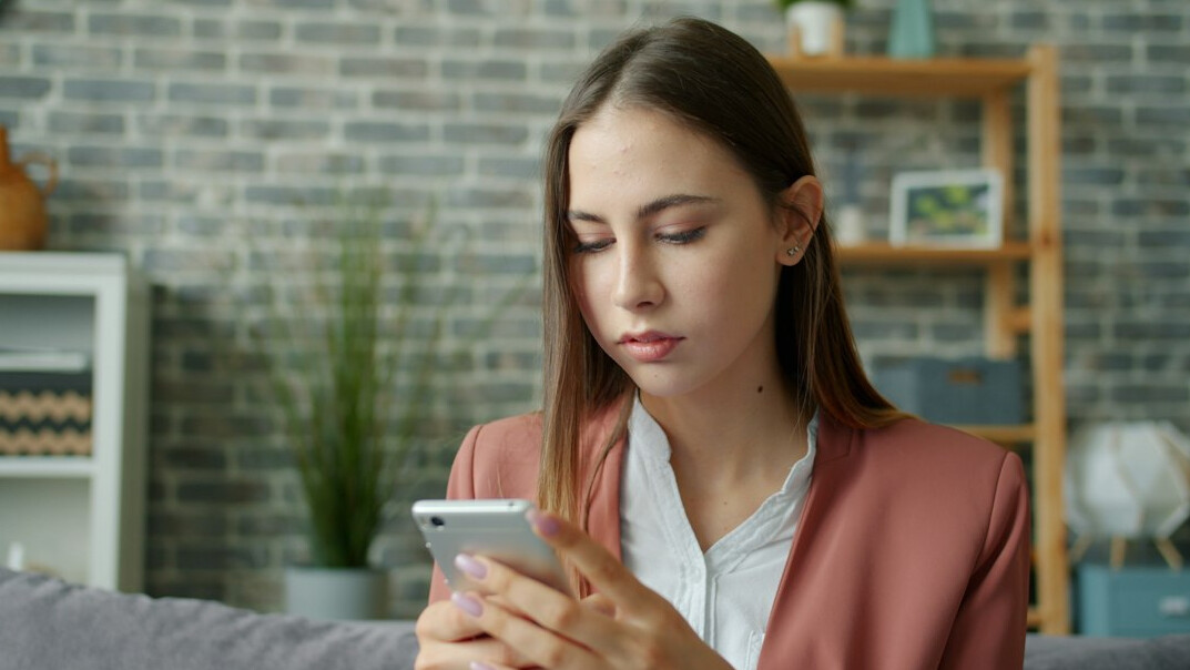 young woman reading news on phone