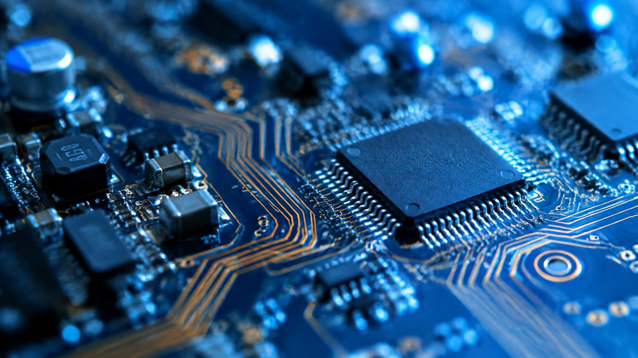 Close up of an electronic circuit board with blue light
